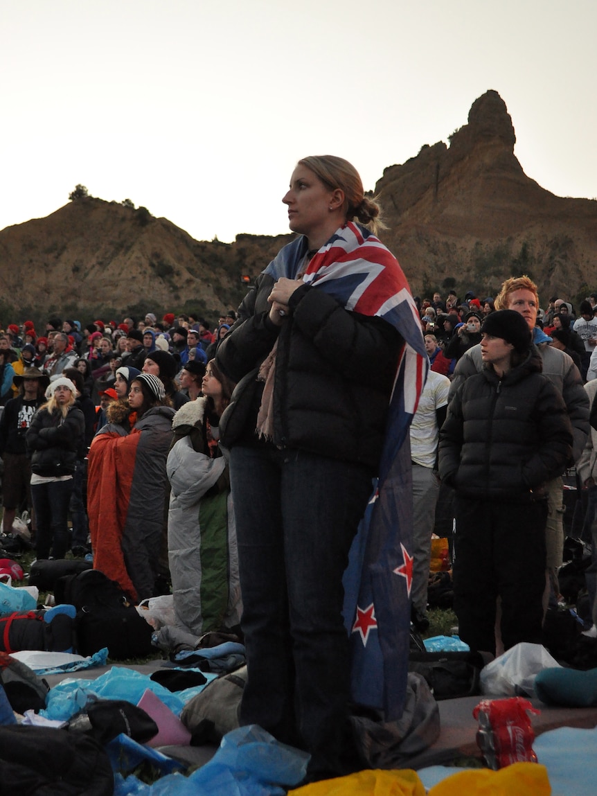 A woman wears a flag during a Anzac Dawn Service at Gallipoli.