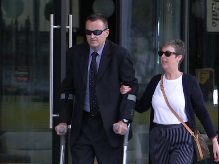 Former ACT police officer William Bonner on crutches outside court with a companion.
