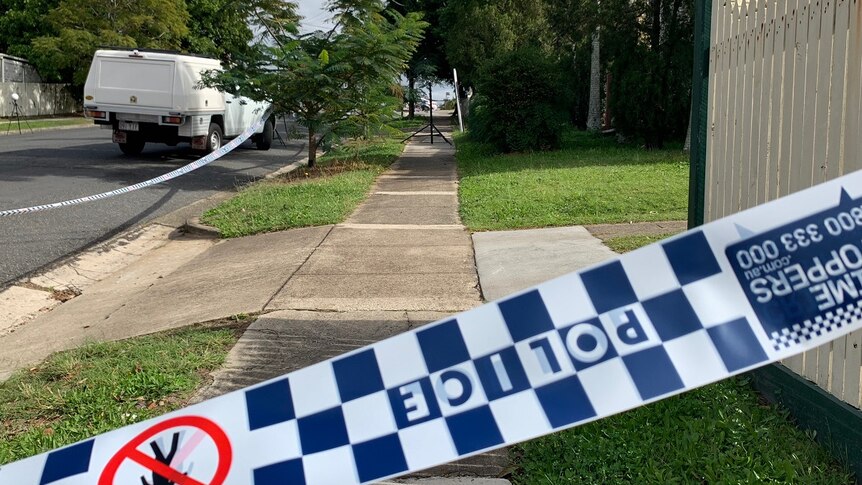 Police tape across a footpath in Annerley where a man was found with stab wounds.