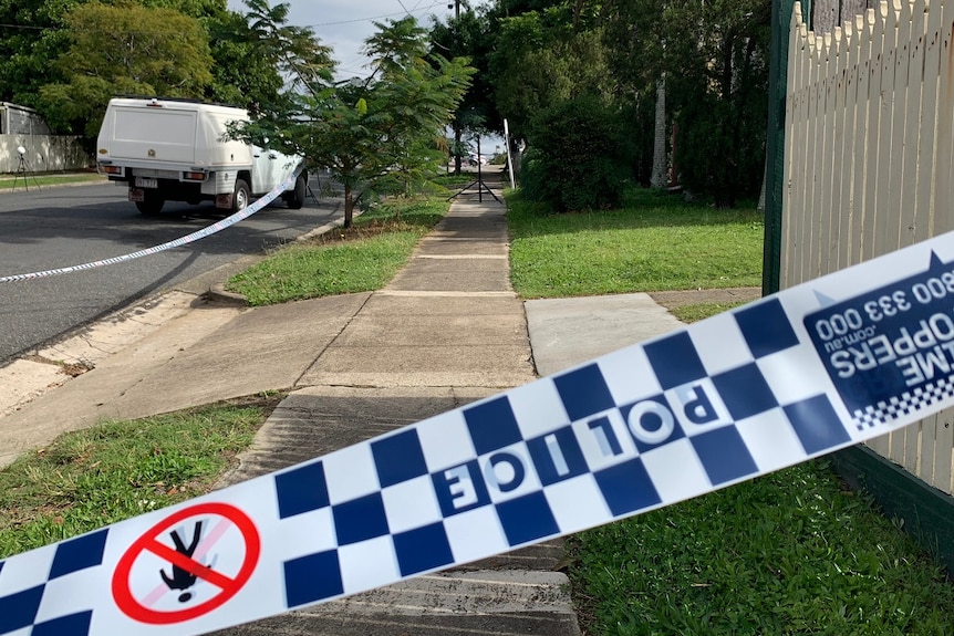 Police tape across a footpath in Annerley where a man was found with stab wounds.