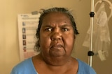 Leah Dolby sits in front of a dialysis machine.