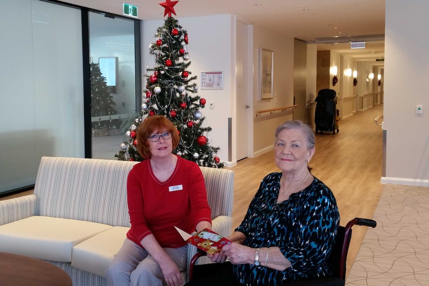 Joan McPherson sits with nursing home manager Judy Carter