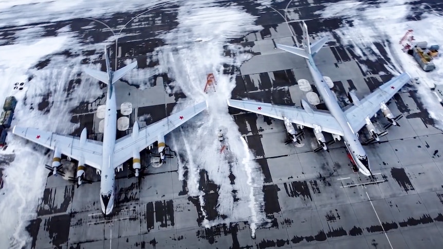 Two bomber aircraft on a runway seen from above. 