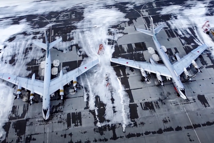 Two bomber aircraft on a runway seen from above. 