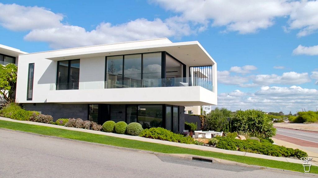 A modern house and garden on a coastal property.