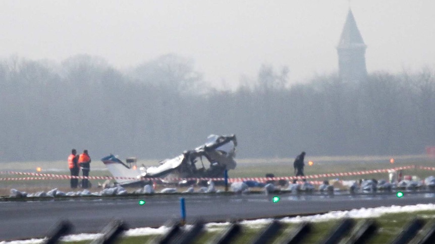 Rescuers gather around a crashed Cessna passenger plane at Brussels South airport in Charleroi.