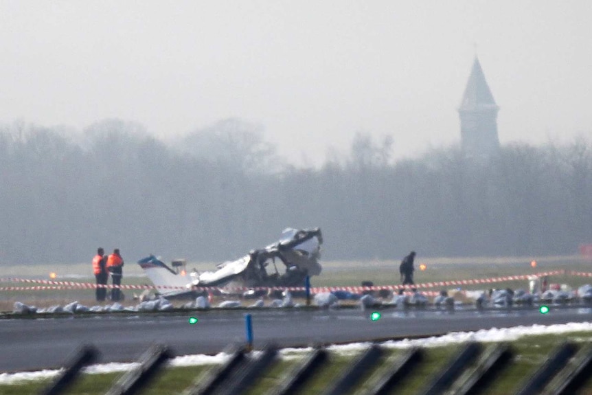Rescuers gather around a crashed Cessna passenger plane at Brussels South airport in Charleroi.