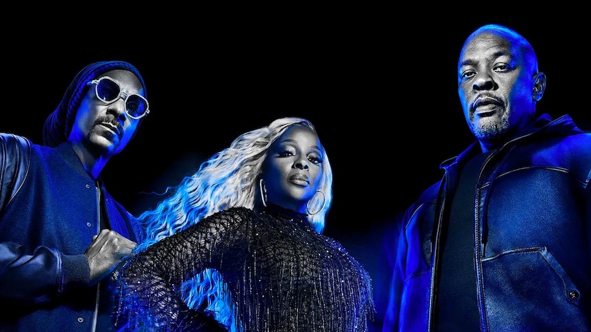 Snoop Dogg, Mary J. Blige, Dr. Dre stare into the camera. There is a blue tint over the image.