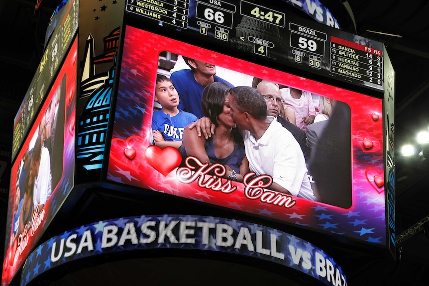Mr and Mrs Obama kiss on the Kiss Cam at the basketball