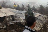 Algerian rescue teams working next to the wreckage of an C-130 Hercules aircraft after it crashed into Mount Fertas on February 11, 2014