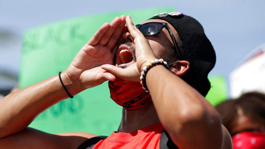 A protester chants in Miami