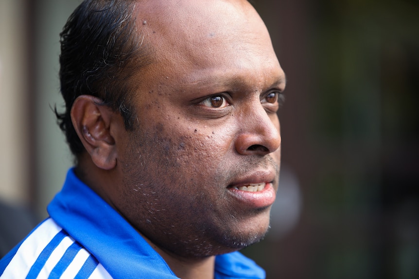 A close up shot of Aswath who wears a blue coloured top