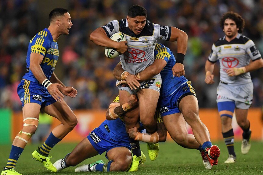 Jason Taumalolo stands in a tackle with the ball against the Eels.