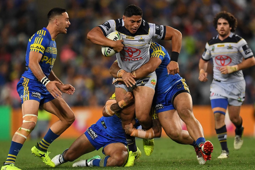 Jason Taumalolo stands in a tackle with the ball against the Eels.