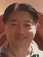 a headshot of Tse Chi Lop wearing a collared shirt and short black hair