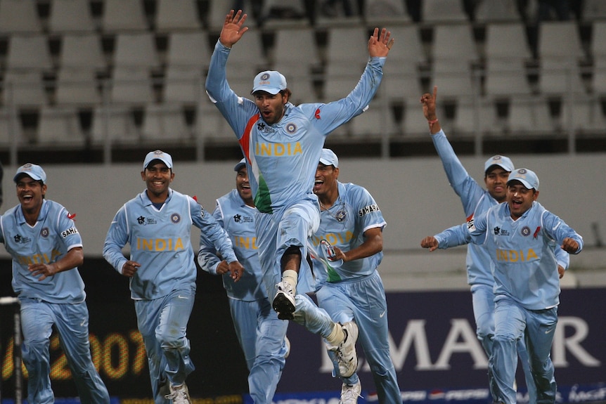 Yuvraj Singh jumps in the air as he leads India running to the middle of the cricket pitch.