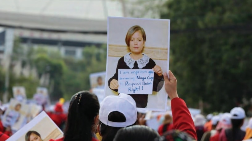 Protester holds photo of woman with short hair at protest