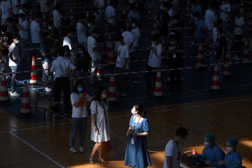 Employees of a stadium in Wuhan line up for mass nucleic acid testing during the outbreak