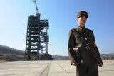 A North Korean soldier stands guard in front of an Unha-3 rocket at Tongchang-ri space centre.