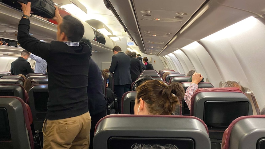 Photo of passengers boarding an aeroplane.