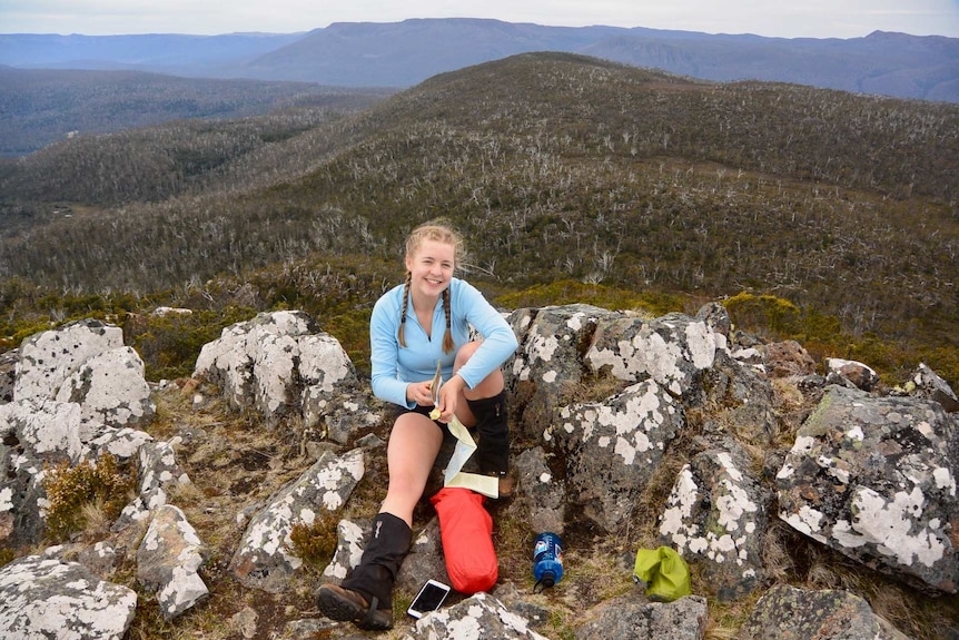 Tasmanian resident Charlie Potter atop a mountain during a hike.