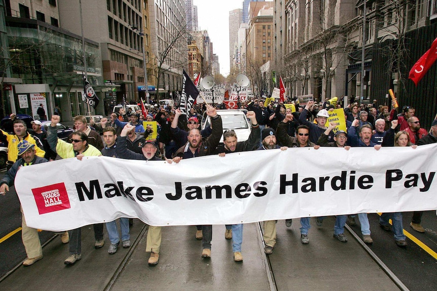 Trade unionists march through the streets of Melbourne calling on James Hardie to compensate asbestos victims.
