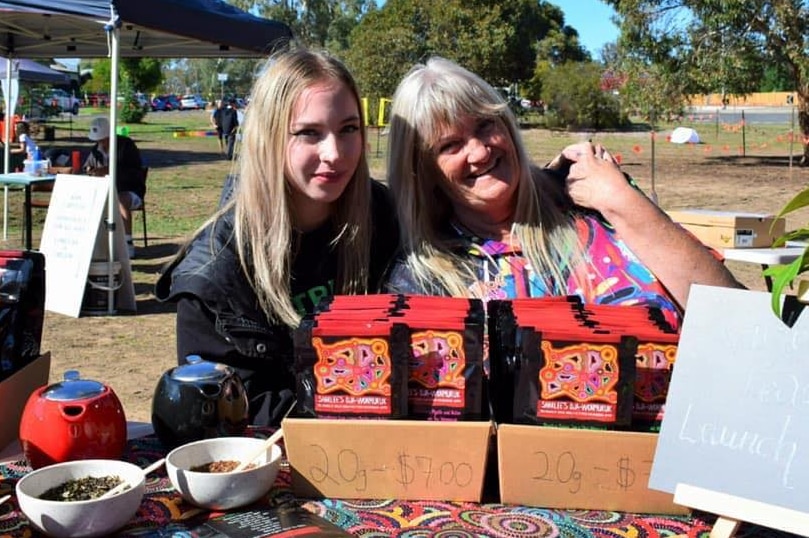 Sharlee Dunolly-Lee and Aunty Julie McHale behind a table laid with Dja Wonmuruk tea and sample teapots.