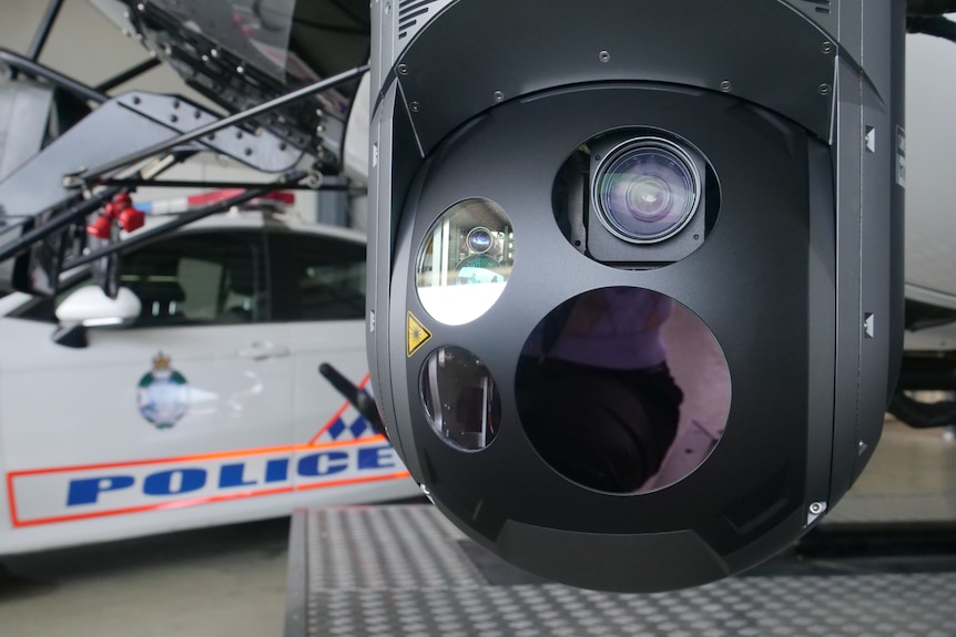 A camera attached to a police helicopter in a hangar.
