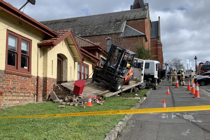 A truck with a forklift on the tray crashed outside the Uniting Ballarat building on Dana Street with emergency services. 