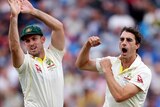 Mitch Marsh and Pat Cummins complete a high five in celebration of a wicket