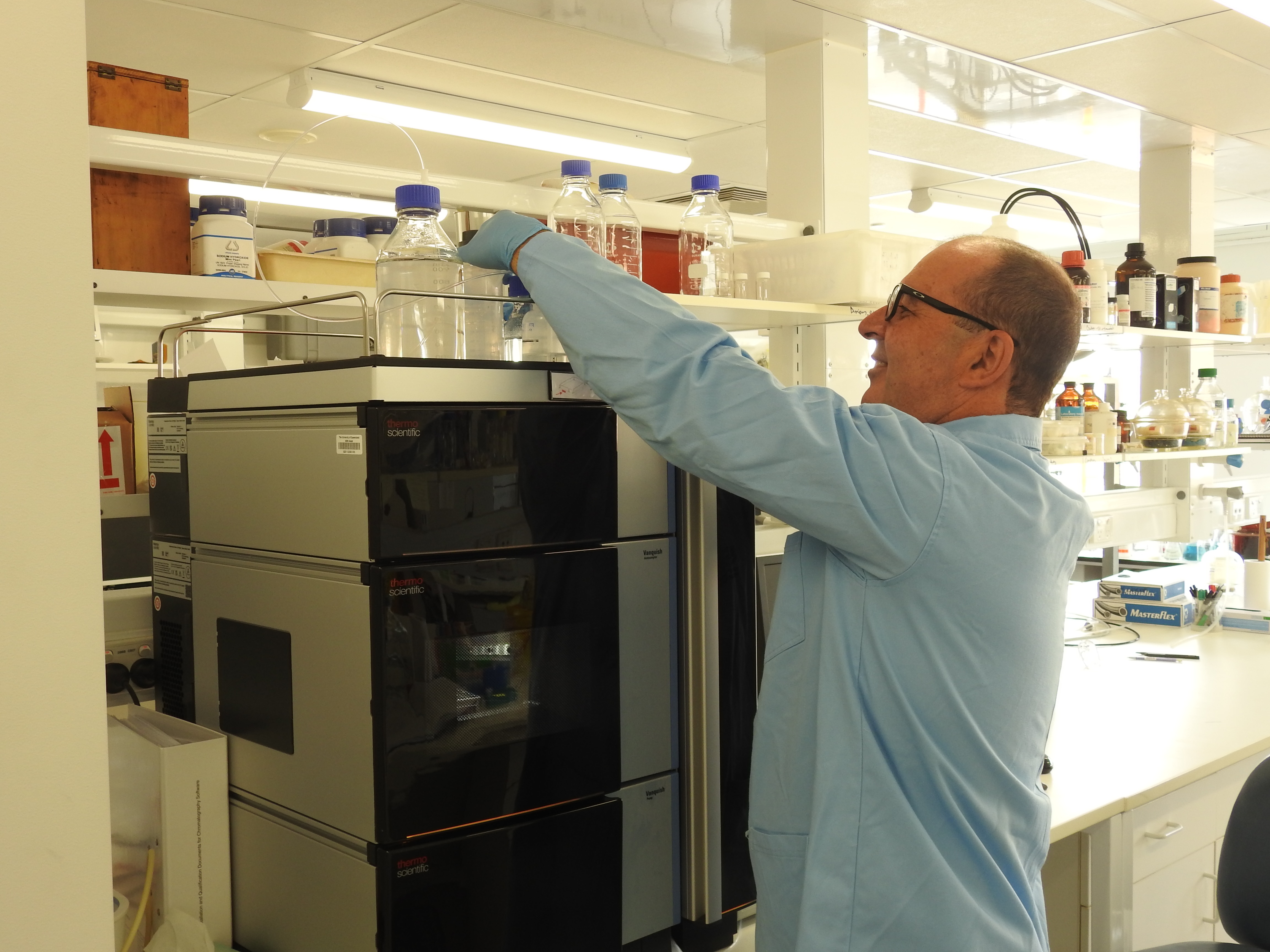 A man wearing a blue coat in a science laboratory 