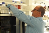 A man wearing a blue coat in a science laboratory 