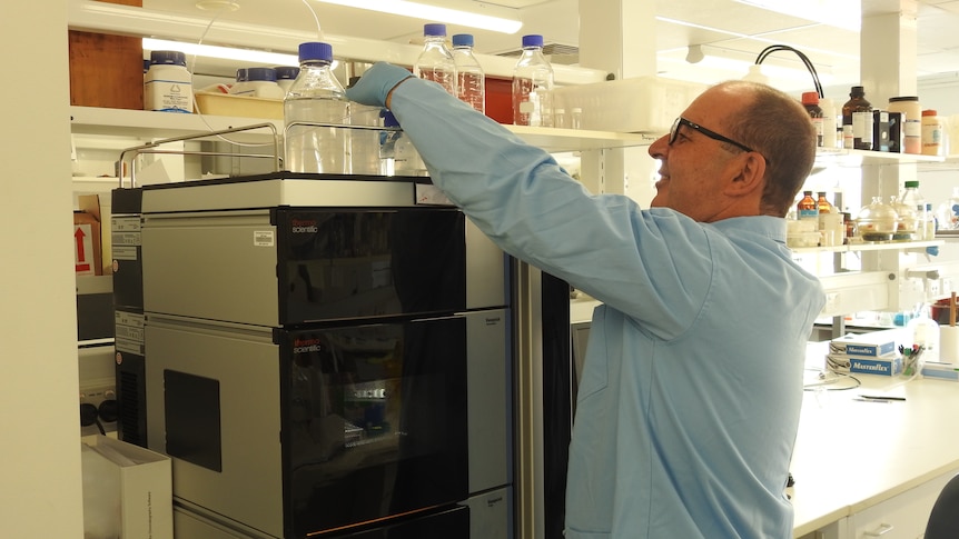 A man wearing a blue coat in a science laboratory 