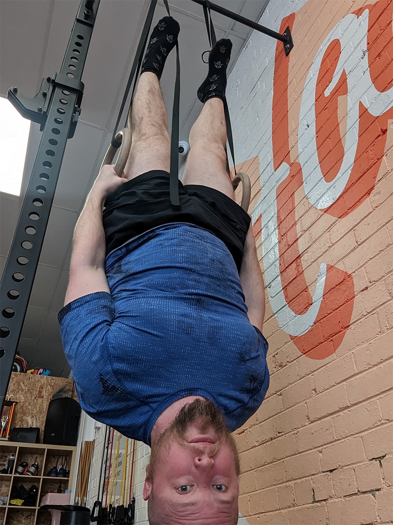 Fergus Randall hanging upside down at Pony Club gym