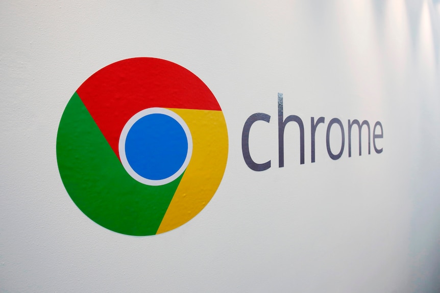 The corporate logo of Google Chrome reproduced on a white wall.