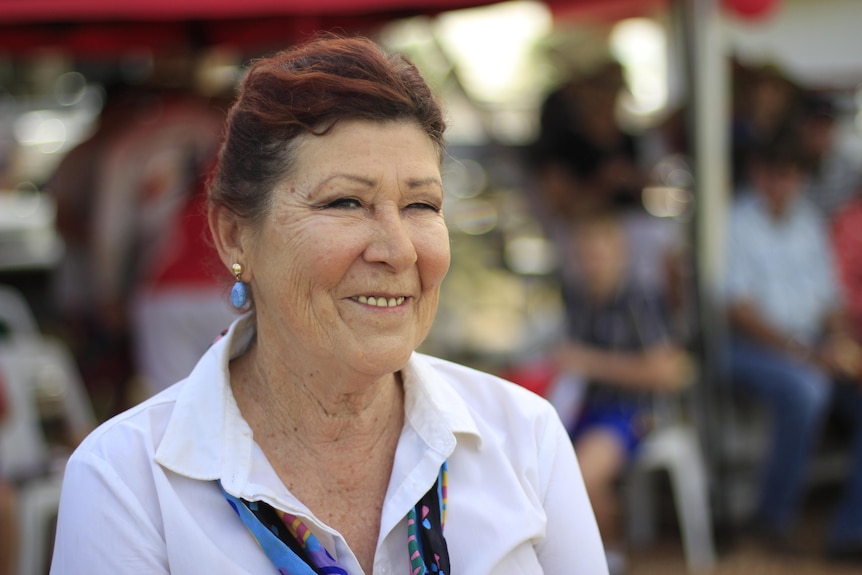 Woman smiling near the cricket stand