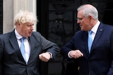 Boris Johnson and Scott Morrison bump elbows outside No 10.