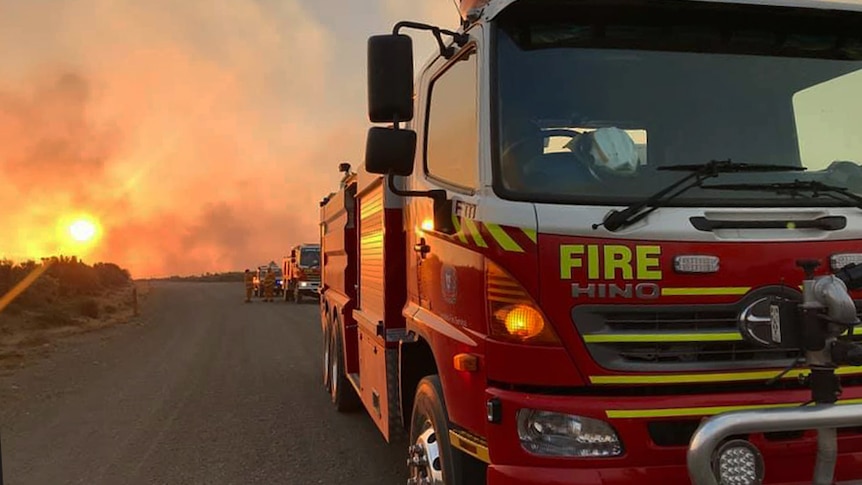 Fire trucks on dirt road at Central Plateau bushfire, Tasmania, January 2019.