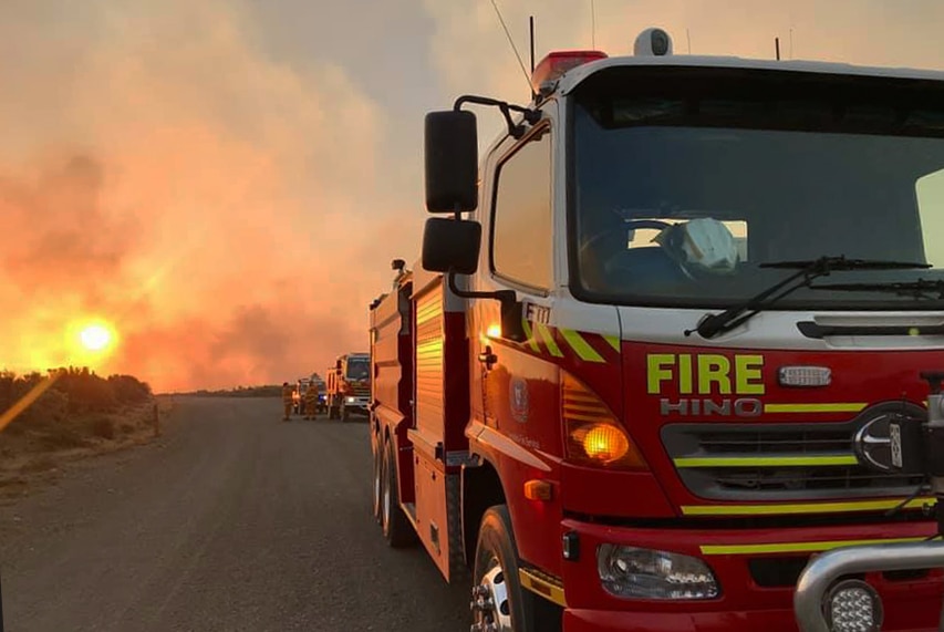 Fire trucks on dirt road at Central Plateau bushfire, Tasmania, January 2019.