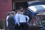 Mourners comfort each other at Elijah Doughty's funeral.
