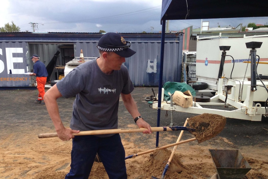 SES worker prepares sandbag