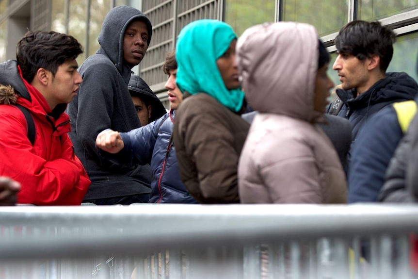 Asylum seekers queueing