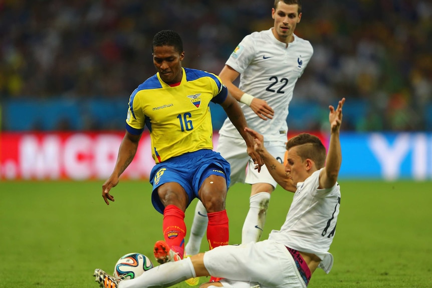 Ecuador's Anotnio Valencia tackles France's Lucas Digne