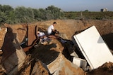 Palestinian boy inspects the damage after an Israeli retaliatory air strike