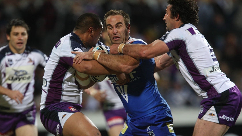 Bulldogs forward Ryan Tandy is tackled by former Storm team-mates Sika Manu and Bryan Norrie at the Adelaide Oval.