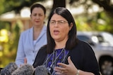 Queensland Education Minister Grace Grace, with Premier Annastacia Palaszczuk in the background, speaks at a press conference.