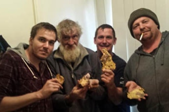 Four men pose with stolen gold.