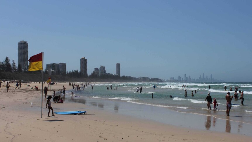Crowds take a dip at Burleigh Heads beach on the Gold Coast