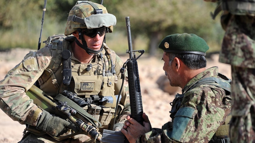 Australian Warrant Officer Andrew Shore talks to an Afghan National Army commander during a patrol of the Mirabad Valley.