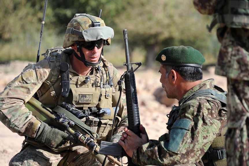 Australian Warrant Officer Andrew Shore talks to an Afghan National Army commander during a patrol of the Mirabad Valley.